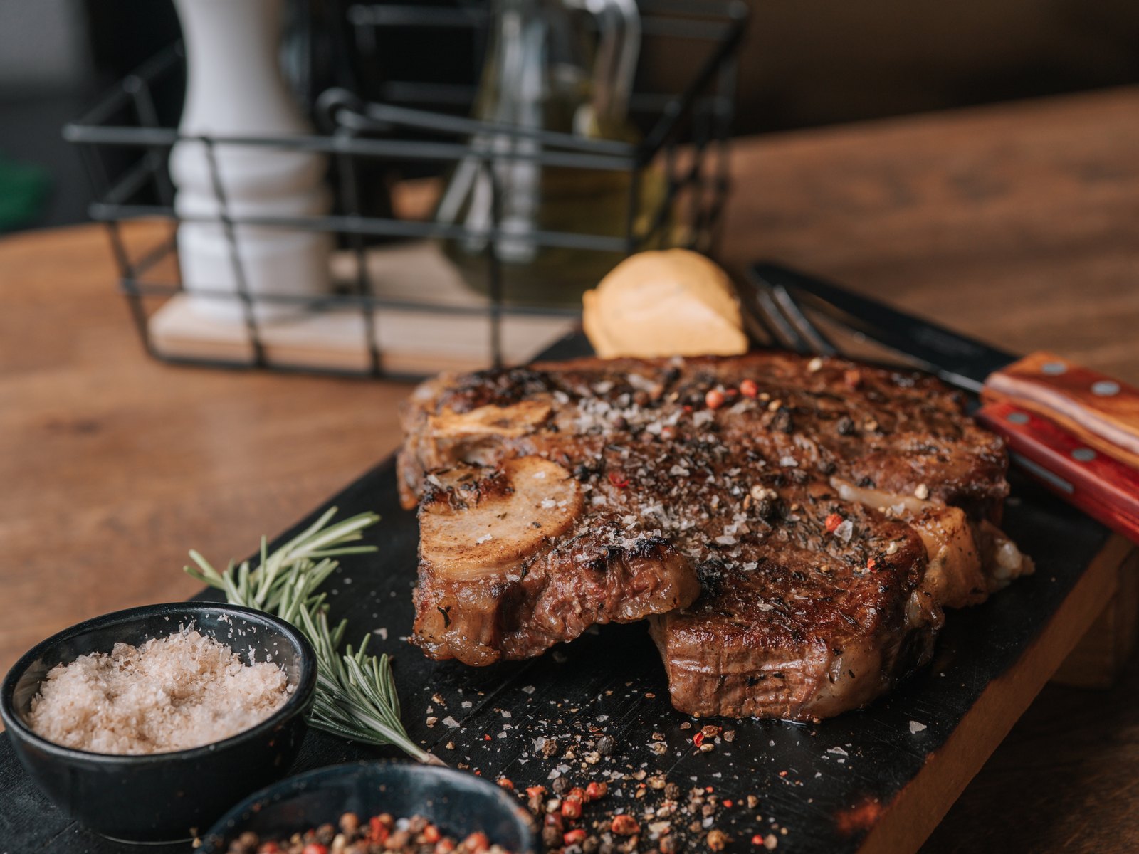 Tomahawk steak — dry-aged beef with sea salt, pepper mills and rosemary